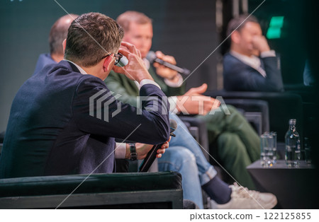 Business professionals engaging in panel discussion at conference Business professionals engaging in panel discussion at conference 122125855