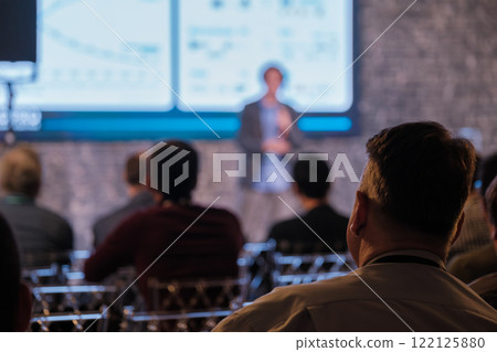 Audience attentively watching business presentation in conference Audience attentively watching business presentation in conference 122125880