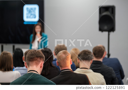 Audience attentively listening to speaker at professional conference or seminar 122125891