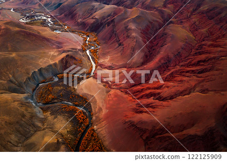 Aerial view of red mountains and winding river in autumn scenery 122125909