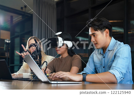 Group team work programer and engineer working AI robot arm system. Group team work programer and engineer working AI robot arm system. 122125940