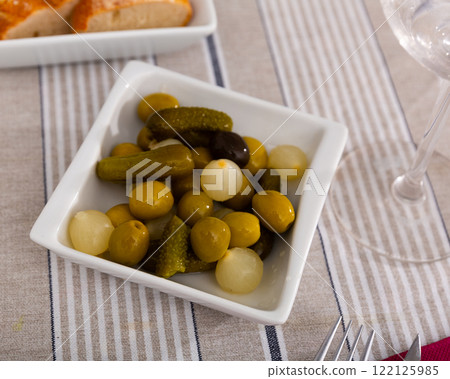 Plate with pickled olives, gherkins and baby onions Plate with pickled olives, gherkins and baby onions 122125985