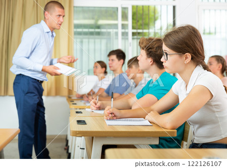 Pupils sitting in class and listening 122126107