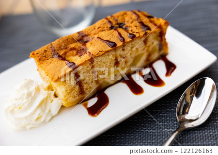 Piece of apple pie with chocolate sauce and cream Piece of apple pie with chocolate sauce and cream 122126163