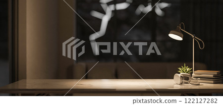A close-up of a space for displaying product on a tabletop in a dark living room at night. A close-up of a space for displaying product on a tabletop in a dark living room at night. 122127282