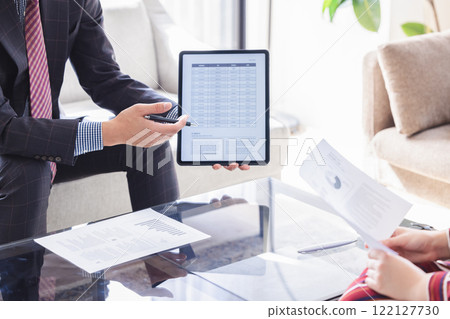 A businessman showing and explaining materials A businessman showing and explaining materials 122127730