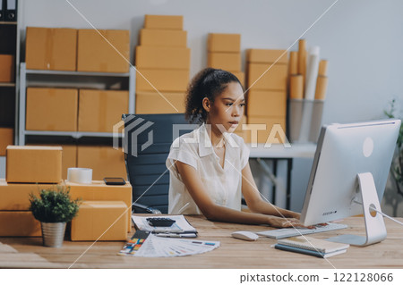 Portrait of Starting small businesses SME owners female entrepreneurs working on receipt box and check online orders to prepare to pack the boxes, sell to customers, SME business ideas online. 122128066