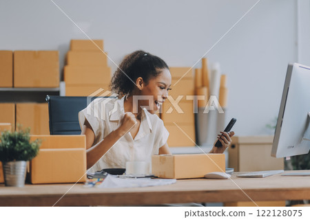 Portrait of Starting small businesses SME owners female entrepreneurs working on receipt box and check online orders to prepare to pack the boxes, sell to customers, SME business ideas online. Portrait of Starting small businesses SME owners female entrepreneurs working on receipt box and check online orders to prepare to pack the boxes, sell to customers, SME business ideas online. 122128075