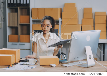 Portrait of Starting small businesses SME owners female entrepreneurs working on receipt box and check online orders to prepare to pack the boxes, sell to customers, SME business ideas online. Portrait of Starting small businesses SME owners female entrepreneurs working on receipt box and check online orders to prepare to pack the boxes, sell to customers, SME business ideas online. 122128076