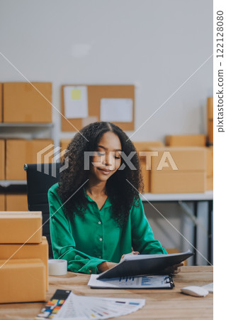 Portrait of Starting small businesses SME owners female entrepreneurs working on receipt box and check online orders to prepare to pack the boxes, sell to customers, SME business ideas online. 122128080