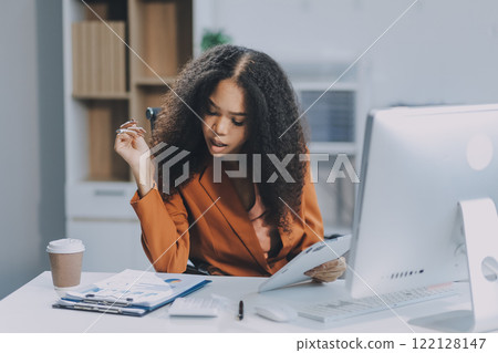 Young happy professional business woman employee sitting at desk working on laptop in modern corporate office interior. Smiling female worker using computer technology typing browsing web. Young happy professional business woman employee sitting at desk working on laptop in modern corporate office interior. Smiling female worker using computer technology typing browsing web. 122128147