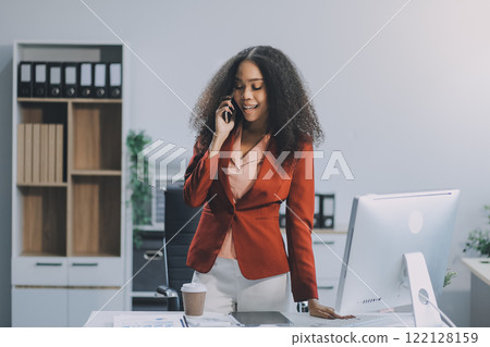 Black businesswoman talking on telephone at desk 122128159