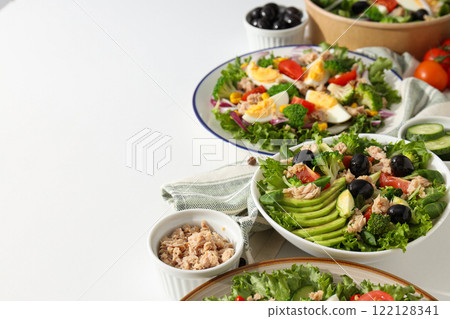 Cooking salad with tuna on a light background. Cooking salad with tuna on a light background. 122128341