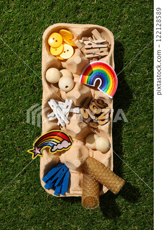 Art supplies in egg tray on green background, top view 122128589