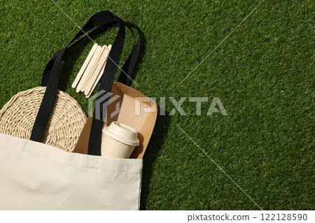 Cotton bag with paper cup, box and tray on green background, space for text Cotton bag with paper cup, box and tray on green background, space for text 122128590