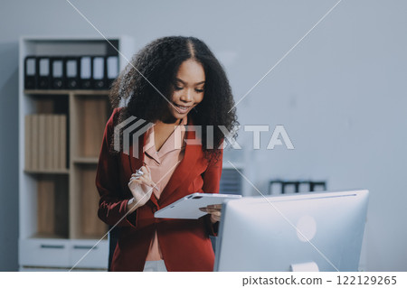 Excited african American woman sit at desk feel euphoric win online lottery, happy black woman overjoyed get mail at laptop being promoted at work, biracial girl amazed read good news at computer 122129265