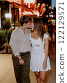 Enjoying a Romantic Evening Stroll in Comfortable and Casual Attire Under the Stars 122129571