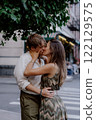A Romantic Couple Embracing Each Other in a Beautiful Urban Green Setting Surrounded by Nature 122129575