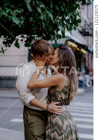 A Romantic Couple Embracing Each Other in a Beautiful Urban Green Setting Surrounded by Nature 122129575
