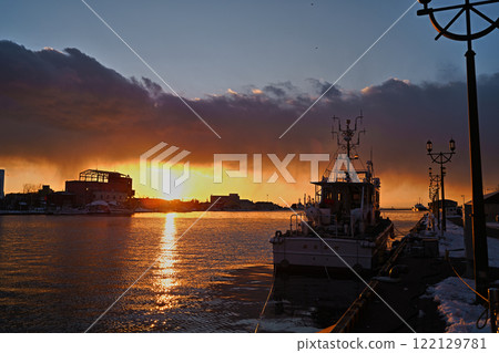 A beautiful sunset reflected on the Kushiro River A beautiful sunset reflected on the Kushiro River 122129781