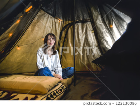 Camping, young woman relaxing in tent Camping, young woman relaxing in tent 122130086