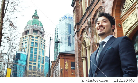 Smiling Japanese businessman in the city 122130446