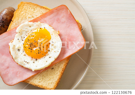 bread toasted cheese topped ham and fried egg with pork sausage 122130676