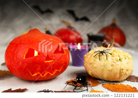 Halloween concept. Halloween pumpkins on a gray wall background with ghosts, bats, spiders, candles, pumpkins. leaves. Halloween concept. Halloween pumpkins on a gray wall background with ghosts, bats, spiders, candles, pumpkins. leaves. 122131221
