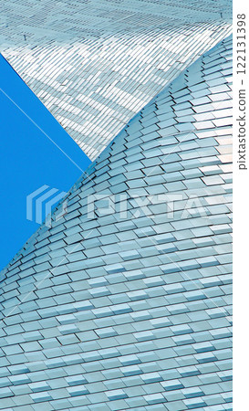 Innovative Architectural Design - Sleek, Textured Metallic Facade with Intricate Overlapping Patterns Reflecting Natural Light, Perfect for Modern Design Portfolios, Urban Development Concepts, or 122131398
