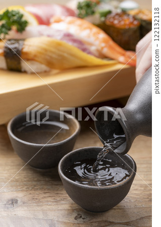 The moment when sake is poured into a sake cup The moment when sake is poured into a sake cup 122132118
