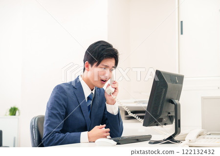 Businessman yelling on the phone 122132432