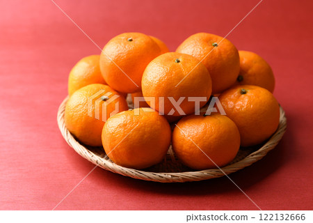 Mandarin tangerine orange fruit in basket on red background, Lucky food in Lunar New Year  122132666