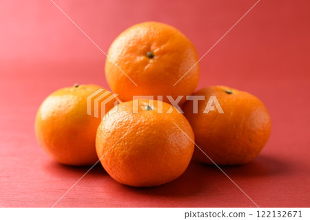 Mandarin tangerine orange fruit on red background, Lucky food in Lunar New Year or Chinese New Year 122132671