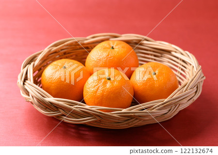 Mandarin tangerine orange fruit in basket on red background, Lucky food in Lunar New Year 122132674