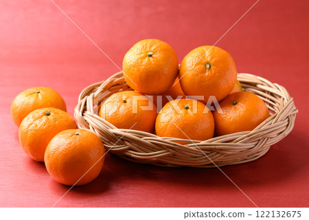 Mandarin tangerine orange fruit in basket on red background, Lucky food in Lunar New Year  122132675