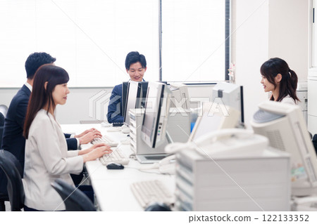 Multiple business people working in an office Multiple business people working in an office 122133352