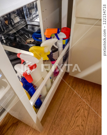 kitchen cabinet with a variety of cleaning supplies organized on pull-out shelf. High quality photo kitchen cabinet with a variety of cleaning supplies organized on pull-out shelf. High quality photo 122134718