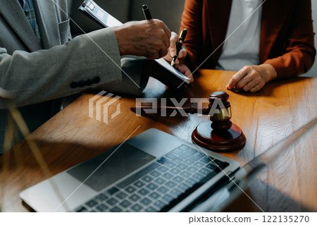 Legal counsel presents to the client a signed contract with legal law. justice and lawyer concept in office. Legal counsel presents to the client a signed contract with legal law. justice and lawyer concept in office. 122135270