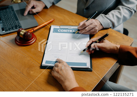 Legal counsel presents to the client a signed contract with legal law. justice and lawyer concept in office. 122135271