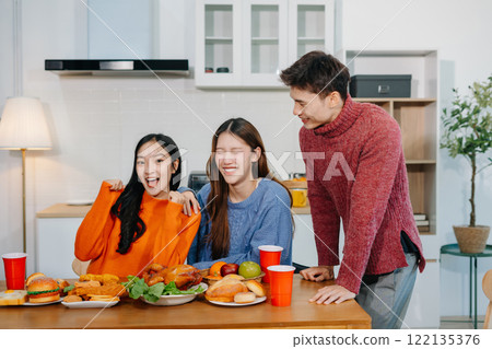 Drinks and conversation, social gathering and get together. Young people, eating pizza and happiness, celebration at home. Drinks and conversation, social gathering and get together. Young people, eating pizza and happiness, celebration at home. 122135376