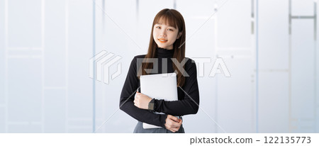 Smiling woman/businesswoman with a computer Smiling woman/businesswoman with a computer 122135773