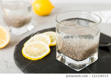 Healthy breakfast or morning with chia seeds and lemon on table background, vegetarian food, diet and health concept. Chia pudding with lemon 122136515