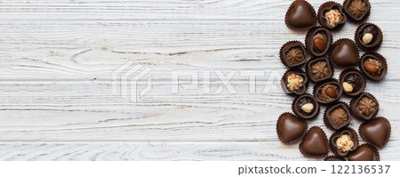 Different kinds of chocolates on colored table close-up. Top View and Flat Lay with copy space Different kinds of chocolates on colored table close-up. Top View and Flat Lay with copy space 122136537
