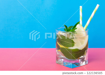 Mojito summer refreshing cocktail with ice and mint. mojito cocktail with lime, lemon and mint in a tall glass with a stick 122136585