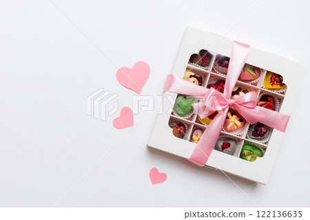 Valentine day composition: sweet candy, with gift boxes with bow and red felt hearts, photo template, background. Top View with copy space Valentine day composition: sweet candy, with gift boxes with bow and red felt hearts, photo template, background. Top View with copy space 122136635