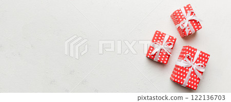 Valentine day composition: red gift box with bow and heart. Christmas present. View from above. Space for text. Holday greeting card 122136703