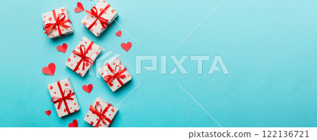 Valentine day composition: red gift box with bow and heart. Christmas present. View from above. Space for text. Holday greeting card 122136721
