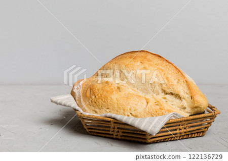 Freshly baked bread on basket against natural background. Perspective view bread copy space Freshly baked bread on basket against natural background. Perspective view bread copy space 122136729