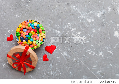 Valentine day composition: sweet candy, with gift boxes with bow and red felt hearts, photo template, background. Top View with copy space 122136749