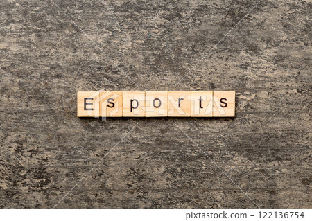 Esports word written on wood block. Esports text on cement table for your desing, Top view concept Esports word written on wood block. Esports text on cement table for your desing, Top view concept 122136754